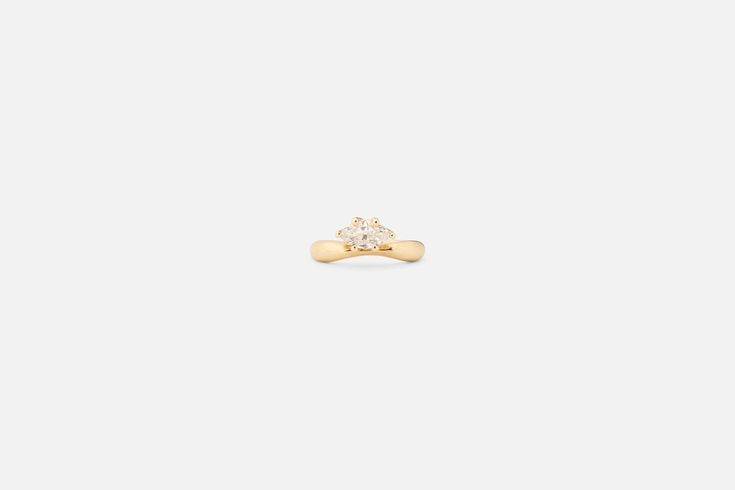 A modern sculptural take on a classic solitaire-- this ring features a one of a kind antique marquis diamond off-set on our Pinch I Ring and designed to stack beautifully with any of our curved or peak bands. Hand crafted in Fairmined 14K gold. one of a kind solid 14K Fairmined gold GIA certified 0.60CT H Color VS1 vintage marquis diamond currently a size 6 but can be resized up or down up to 3 sizes or made to order in your size if you would like this ring resized please write your preferred ri 14k Gold Marquise Cut Diamond Ring With Tension Setting, Yellow Gold Marquise Cut Jewelry With Tension Setting, Marquise Cut Yellow Gold Jewelry With Tension Setting, Luxury Marquise Cut Single Diamond Jewelry, Minimalist Marquise Brilliant Cut Ring, Modern Jewelry With Marquise Cut And Prong Setting, Modern Single Diamond Marquise Cut Ring, Minimalist Marquise Ring With Brilliant Cut, Modern Jewelry With Prong Setting And Marquise Cut