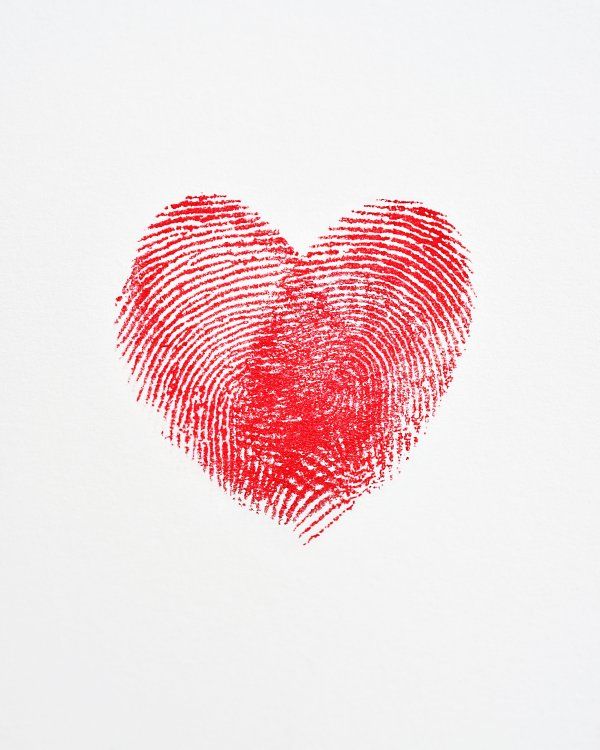 a red fingerprint in the shape of a heart on a white background with space for text