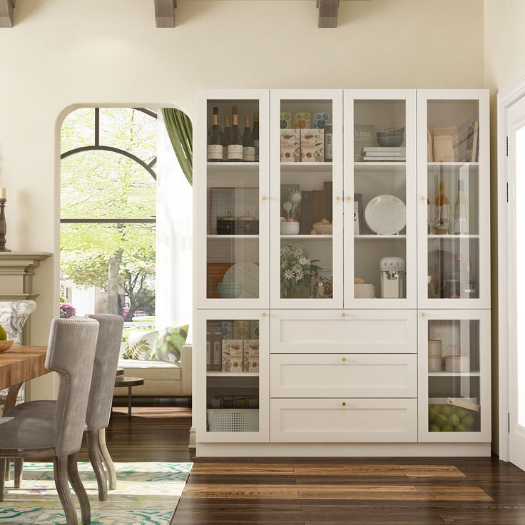 a white china cabinet with glass doors in a dining room