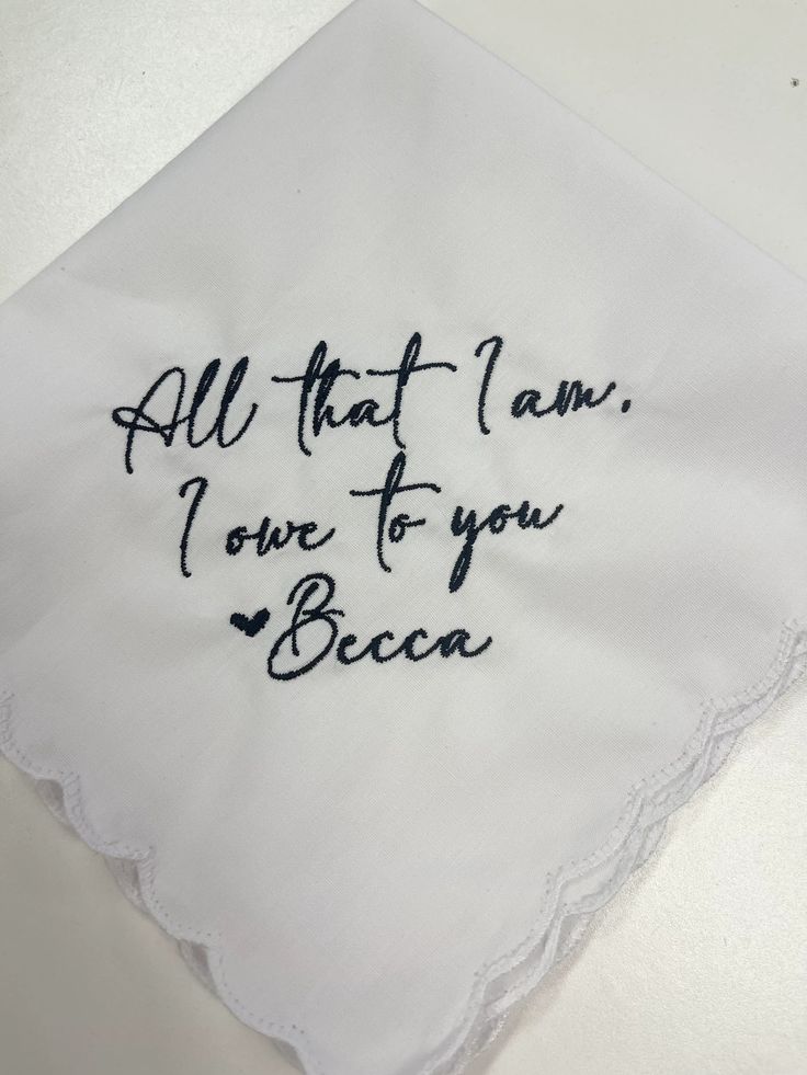 an embroidered handkerchief with the words all that i am, i love to you beca