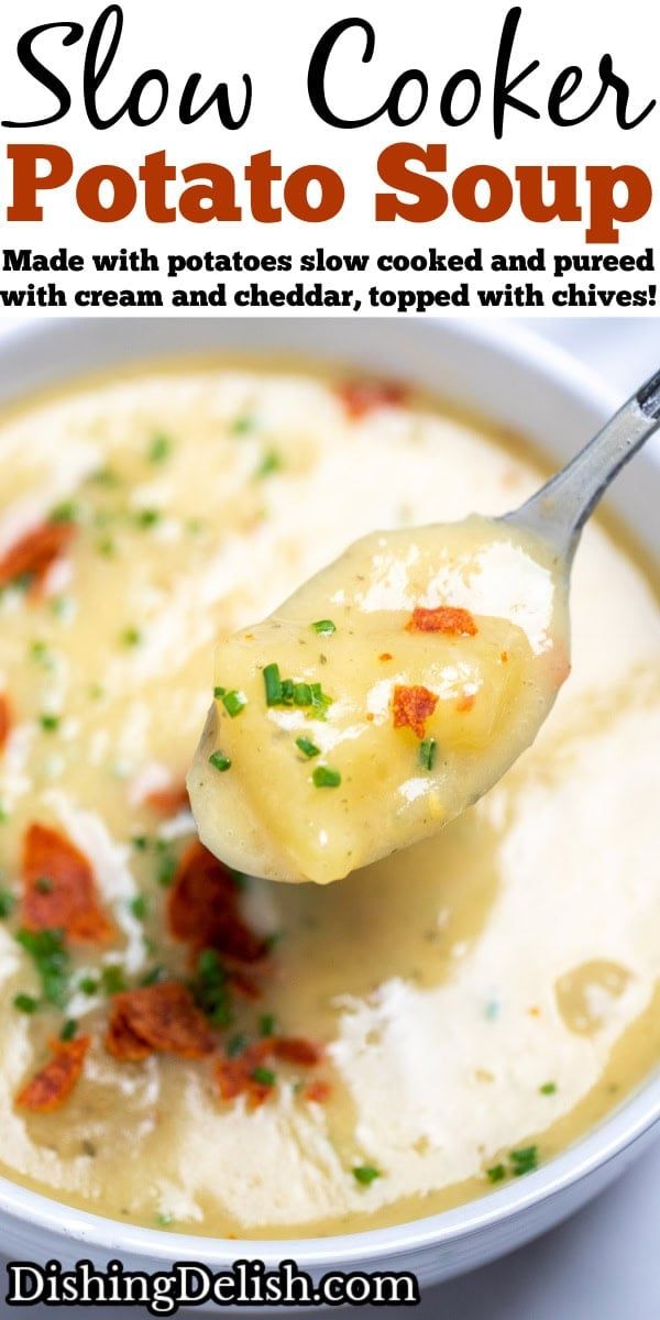 a spoon full of potato soup with bacon and cheese on top, in a white bowl