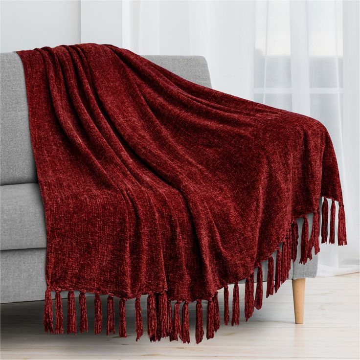 a couch with a red blanket on top of it