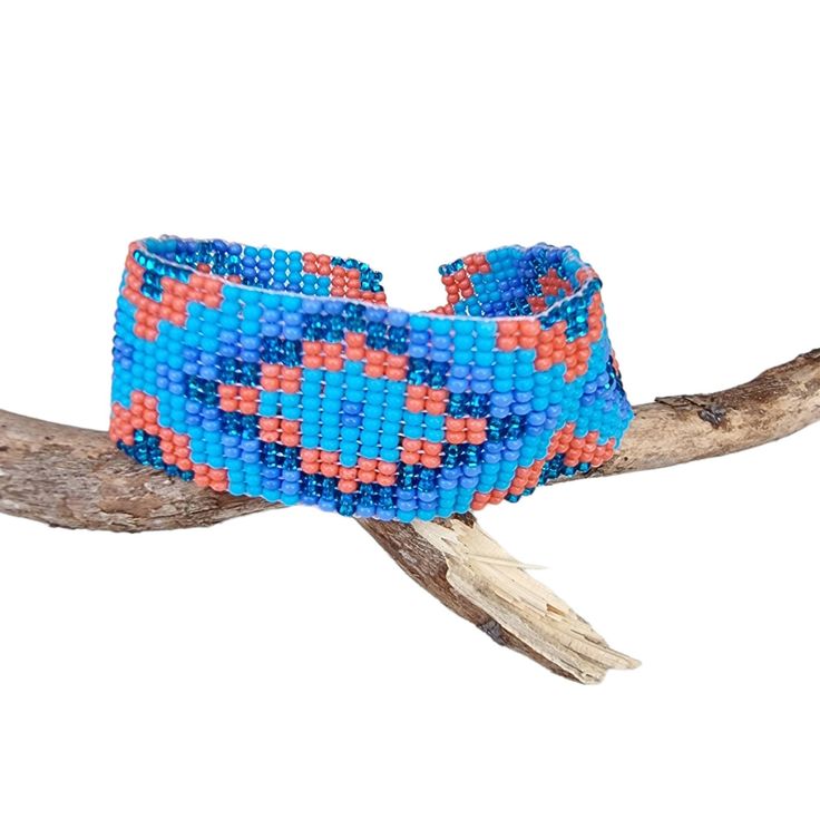 Lovely handmade Huichol beaded bracelet, southwest style,  tribal symbol pattern, light blue, lavender, orange and glitter blue colour, from our Fair Trade partners in Mexico.  Size is approx. between 18.5long cm by 2.5 cm wide. Please also visit my new shop, BALI COCONUT BY ROSA made in Fairtrade partnership with fine Balinese artisans and featuring all natural jewellery: https://www.etsy.com/uk/shop/BaliCoconutbyRosa Spend over $35 US Dollars with us and receive FREE postage for orders to the Bohemian Blue Bracelets With Colorful Beads, Blue Bohemian Bracelets With Colorful Beads, Southwestern Style Multicolor Handwoven Beaded Bracelets, Blue Artisan Adjustable Beaded Bracelet, Bohemian Blue Hand-strung Bracelets, Adjustable Artisan Blue Beaded Bracelets, Adjustable Blue Artisan Beaded Bracelets, Southwestern Style Large Beads Bracelet For Festivals, Bohemian Woven Bracelets With Round Beads