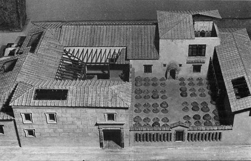 an aerial view of a building with many windows and balconies on the roof