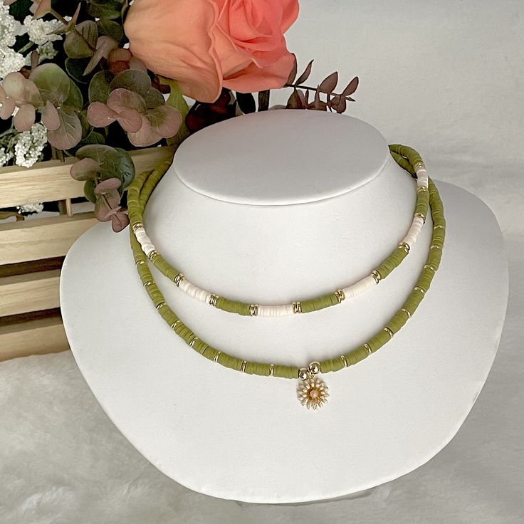 Heishi necklace, olive green necklace, Heishi boho necklace, dainty flower necklace, simple beaded necklace, summer bead necklace. These boho chic chokers are very trendy and they match with your daily outfit. If you are looking for stylish summer necklace to enhance your daily outfit, you found them! They're easy to wear everyday alone or layered with other favorite necklaces. 💕 ITEM DETAILS: Length: 14 - 16 inches. The length of the necklace refers to the total length from end-to-end. Materia Dainty Green Jewelry For Beach, Bohemian Summer Necklace With Flower Pendant, Bohemian Flower Pendant Necklace For Summer, Green Adjustable Necklace With Flower Charm, Adjustable Green Flower Necklace With Round Beads, Dainty Green Adjustable Beaded Necklaces, Bohemian Flower Necklace With Tiny Beads, Adjustable Dainty Green Necklace, Green Bohemian Flower Charm Necklace