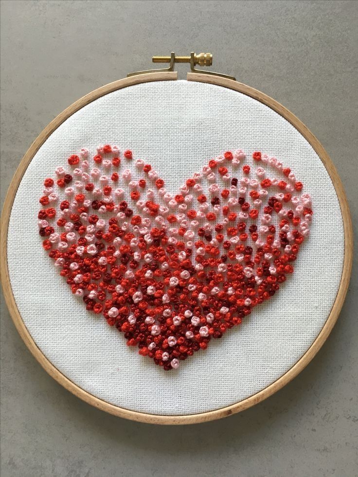 a red and white heart made out of beads