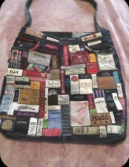 a handbag made out of old clothes on a bed