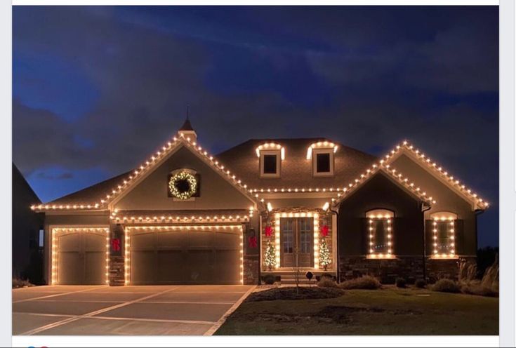 a house is decorated with christmas lights and wreaths