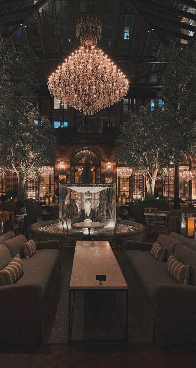 an elegant lobby with chandelier and couches