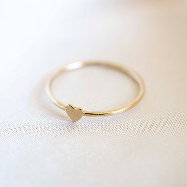 Our handmade 14k Gold Filled Heart Stacker will be a new staple in your ring collection. Simply wear it on it's own or stack together with other rings. Material: 14k Gold Filled Approximately 2mm in thickness. Heart Ring Gold, Minimalist Gold Ring, Dainty Band, Gold Heart Ring, Unusual Rings, Gold Filled Ring, Gold Band Ring, Ring Minimalist, Cute Rings