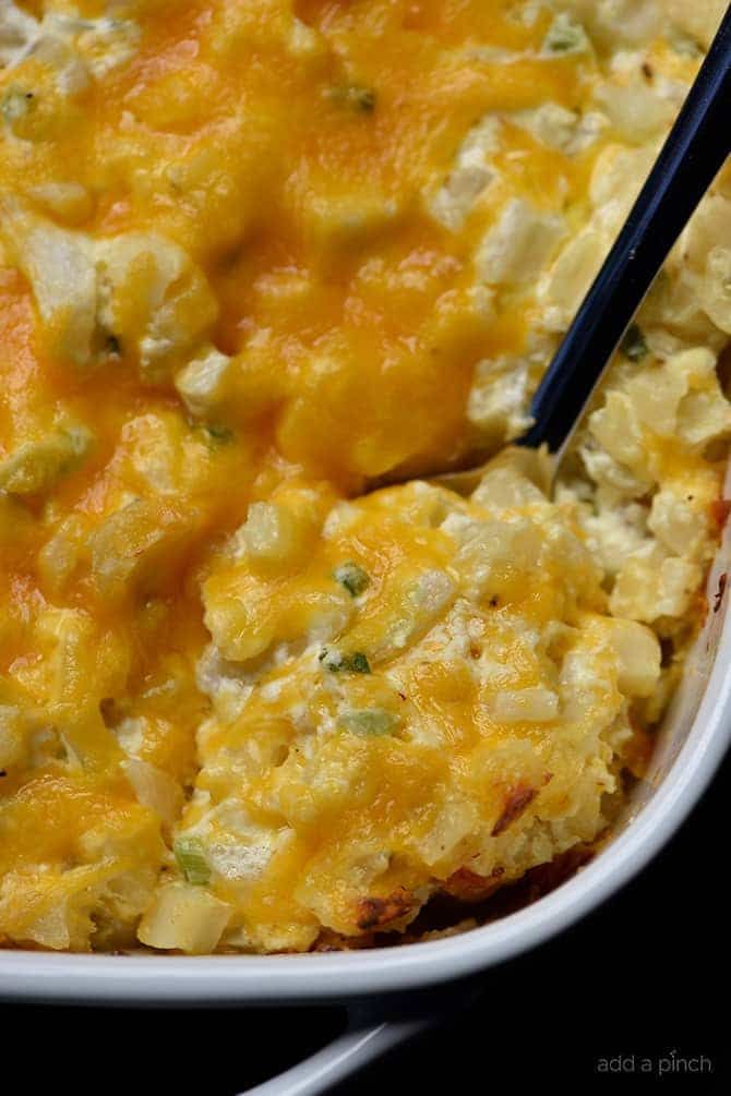 a casserole dish with broccoli and cheese in it, ready to be eaten