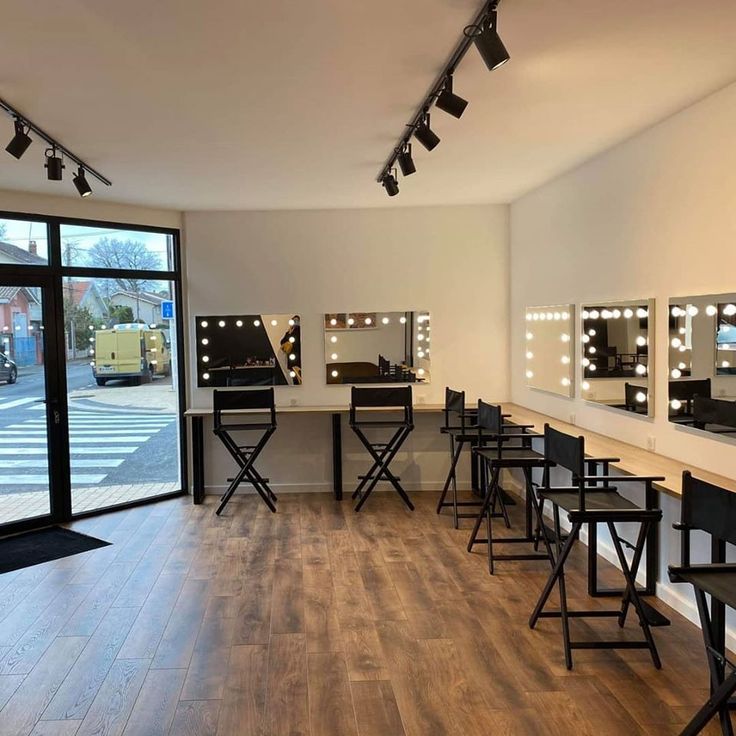 an empty room with chairs and lights on the wall