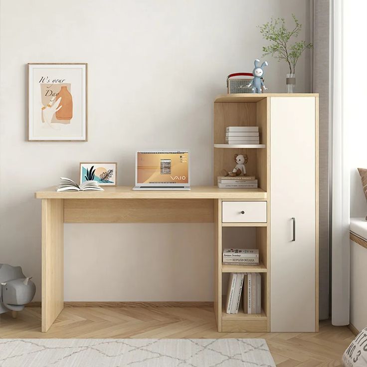 a wooden desk sitting next to a window in a room with white walls and wood flooring