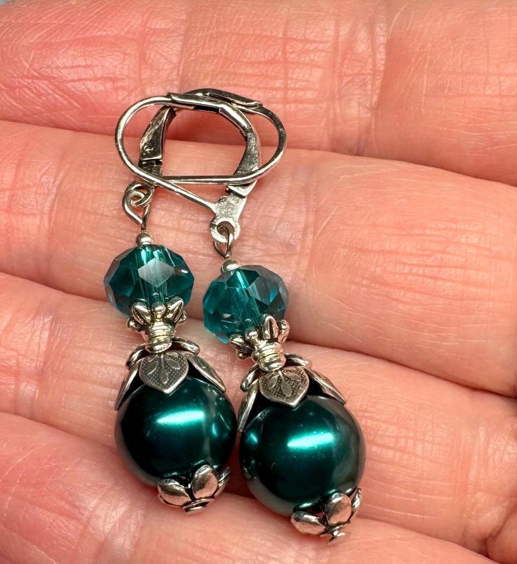 Dark teal crystal pearls and teal glass beads make up these earrings . I have dressed earrings with  antiqued silver plated bead caps to give them a Victorian feel. The earrings are 1 3/4 inches long.  All orders come in a gift box or gift bag. Turquoise Pearl Earrings, Victorian Style Earrings, Teal Glass, Teal Earrings, Vintage Style Earrings, Earrings Turquoise, Earrings Pearl, Dark Teal, Earrings Vintage