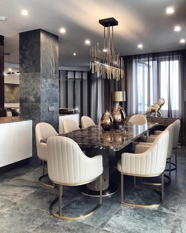 an elegant dining room with marble table and chairs