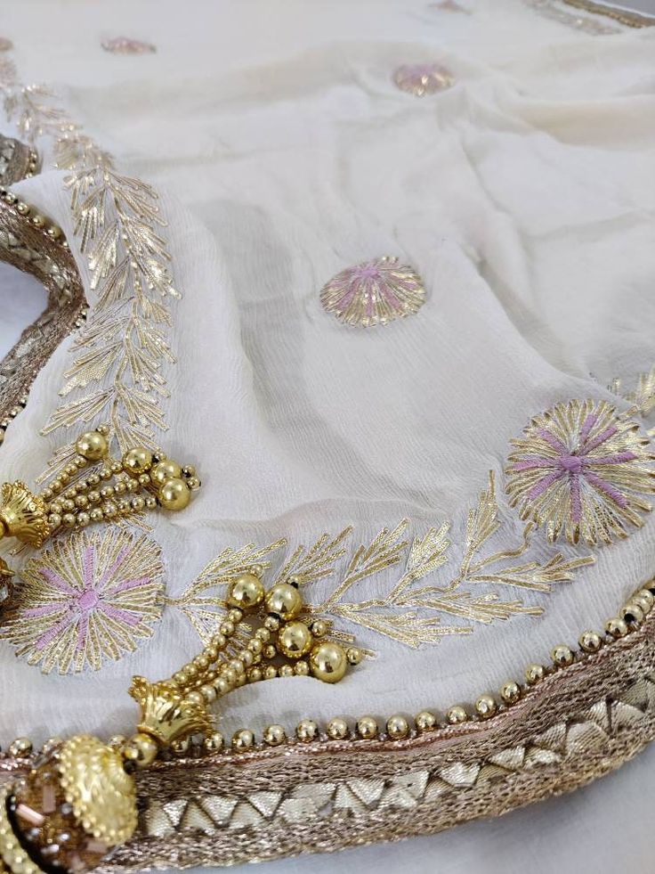 Item Overview ATHARVA Hand Embroidered/Indian Wedding Dupatta in Cream Off White/Gota Patti Work/Beaded Border/Chiffon Chinnon /Tassels/Stolls/Wrap ⚘Dno. GP30 ⚘ Fabric Soft Chiffon Chinnon Dupatta ⚘Hand Embroidered Gota Patti Dupatta/ Stole/ Scarf in Black ⚘Fabric: Options Available A. Net B. Organza C. Chiffon Chinnon D. Georgette E. Tabby Silk F. Pure Chiffon (Chamandi) ⚘Length: 2.5 Mtrs ⚘Width: 1.12 Mtrs ⚘Excusive Hand Embroidered Gota Patti Work ⚘Excusive Hand Embroidered Party Wear. ⚘Custom White Traditional Sets With Tassels, Traditional White Sets With Tassels, White Sets With Tassels For Festivals, Eid Wedding Sharara With Tassels, Bohemian Wedding Sharara With Dori Work, Bohemian Sharara With Dori Work For Wedding, Traditional Saree Sets With Tassels, Georgette Sets With Tassels In Traditional Drape Style, Wedding Sets With Tassels For Diwali