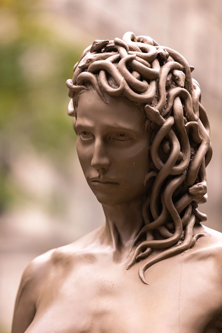 a statue of a man with braids on his head