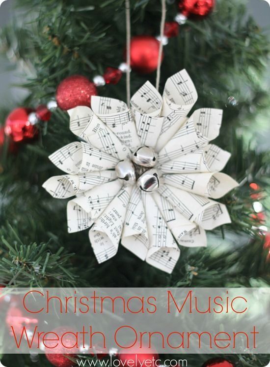 an ornament made out of sheet music on a christmas tree