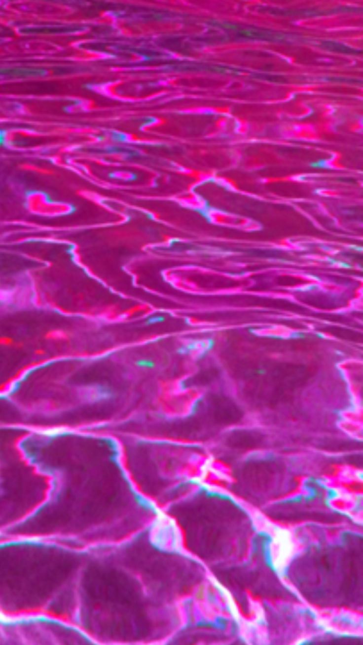 the water is pink and blue with some bubbles in it, as well as other colors