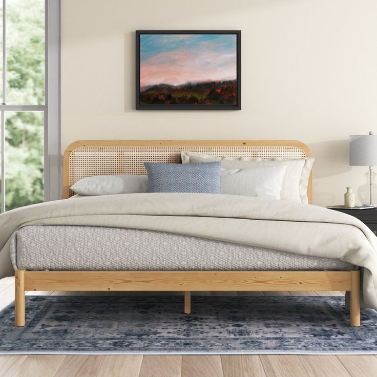 a bed with white linens and pillows in a bedroom next to a large window