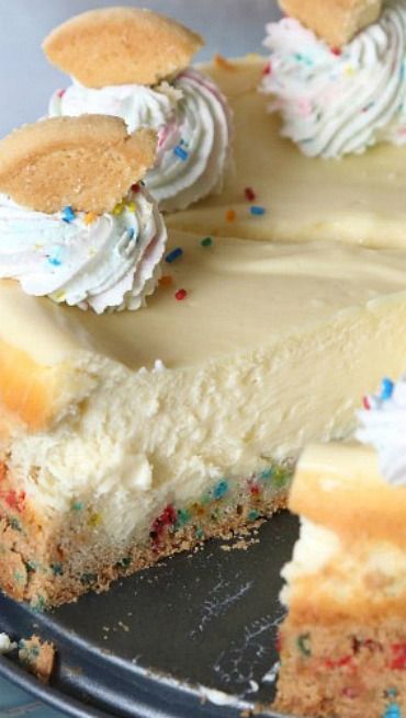 a cake with white frosting and colorful sprinkles on it's edges