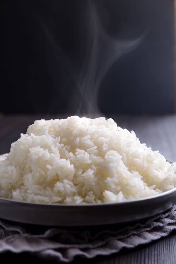 a white plate filled with rice on top of a table