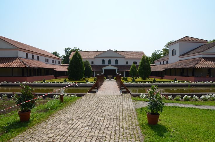 a brick walkway leads to several large white buildings