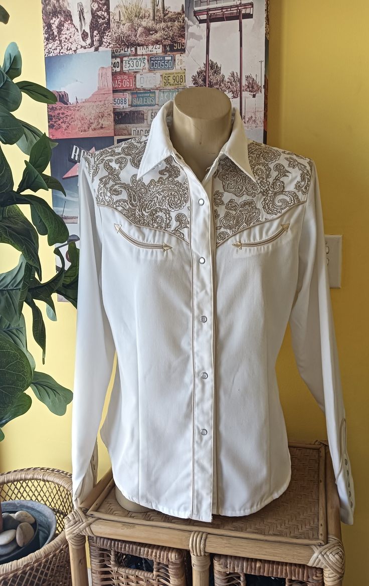 This Shirt is Super Cool 😎 in as new condition, can be gender neutral very well made, features paisley embryon shoulders, iconic western pearl esq snap buttons, and piping. Made in Macau it is 65% Polyester 35% Rayon.  Measurements: Collar 16" Across Shoulders 16" Shoulder Seams 5" Armhole Clearance 20" Sleeves 25.5" Cuff 2.5" Highest Point 7" with 5  Buttons Wrists 8"  Chest 38" Waist 35" Hips 38" Length from Shoulder Seams 25.5" Fitted Shirt With Button Closure For Western-themed Events, Vintage Western Pearl Snaps, Snap Button-up Tops For Rodeo, Button-up Tops With Snap Buttons For Rodeo, Western Snap Button-up Tops, Western Show Shirts, Cowgirl Aesthetic, Western Shirt, Western Shirts