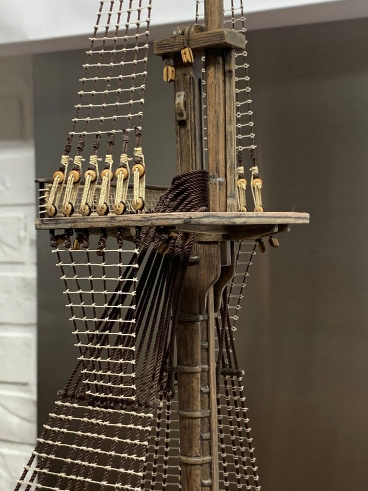 a wooden structure that has many bottles on the top of it and some wires attached to it