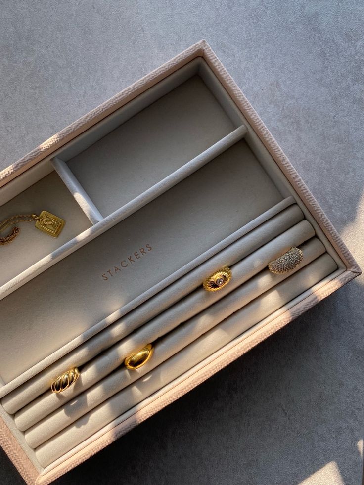 an open jewelry box sitting on top of a table