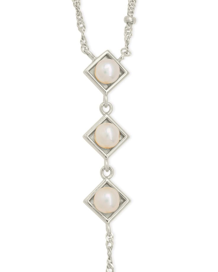 Introducing the Reine Lariat Necklace, a luxurious piece crafted for the sophisticated individual. This elegant necklace features a delicate beaded chain adorned with lustrous pearls, exuding an air of exclusivity and refinement. Elevate any outfit with the timeless style and grace of the Reine Lariat Necklace. Material: 14K gold or rhodium plated brass, freshwater pearls Features: Measures 16" with 2" extender, 3.75" drop, 0.35" pendants, 5mm pearls, 2mm chain, Lead & Nickel free, lobster clasp Formal Pearl Dangle Necklaces, Elegant Sterling Silver Lariat Necklace, Formal Pearl Lariat Necklace, Formal Backdrop Necklace With Pearl Pendant, Elegant Pearl Lariat Dangle Necklace, Elegant Pearl Lariat Necklace With Dangle, Formal Dangle Lariat Necklace With Pearl Drop, Formal Dangle Pearl Drop Lariat Necklace, Elegant Sterling Silver Pendant Lariat Necklace