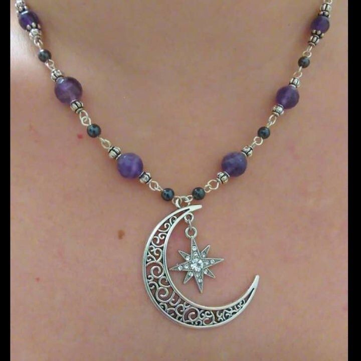 Made with Genuine faceted 8mm Amethyst and 4mm Hematite gemstones. Center focal filigree silver plated Crescent Moon with radiant starburst crystal charm. Fine silver plated findings and wire, Crescent Moon pendant focal measures approximately. 2 in. Necklace length 18in with 2in extender chain. Lobster Claw clasp. Matching earrings also available soon! Comes Gift boxed. *Custom Orders Welcome* Silver Crystal Necklace With Spacer Beads As Gift, Silver Wire Wrapped Crystal Necklaces, Silver Celestial Crystal Necklaces For Jewelry Making, Celestial Silver Crystal Necklaces For Jewelry Making, Celestial Silver Gemstone Crystal Necklaces, Mystical Silver Amethyst Crystal Necklace, Celestial Silver Crystal Necklace With Natural Stones, Mystical Silver Necklace With Round Beads, Mystical Silver Gemstone Bead Necklace