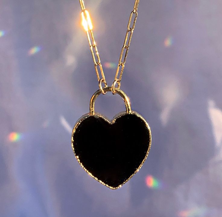 This adorable necklace features a heart shaped black onyx stone that has been electroformed in gold or silver and hangs from your choice of 14k gold filled or sterling silver drawn cable chain. Stones natural and each is one of a kind. Each will vary slightly since they are natural, but will be just under 1 inch. Necklace is adjustable and can be worn anywhere from 15 to 18 inches. Every item arrives in a lovely little gift box. 😘 Thanks for stopping by! ❤️ xoxo, Amy Elegant Black Heart Necklace With Adjustable Chain, Black Open Heart Jewelry For Valentine's Day, Elegant Black Charm Necklace, Minimalist Black Heart Jewelry, Minimalist Black Heart-shaped Jewelry, Valentine's Day Black Open Heart Jewelry, Black Heart Charm Pendant Necklace, Black Heart-shaped Jewelry, Black Round Pendant Jewelry For Valentine's Day