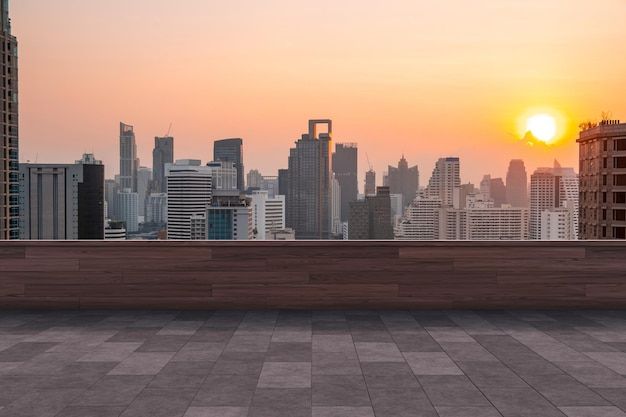 the sun is setting over a cityscape with tall buildings in the foreground