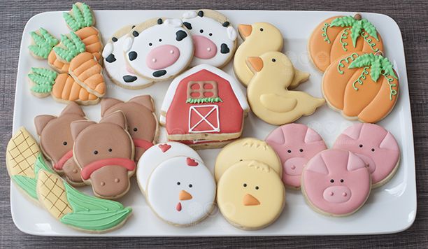 decorated cookies on a plate with farm animals