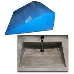 a large blue object sitting on top of a cement floor next to an empty square