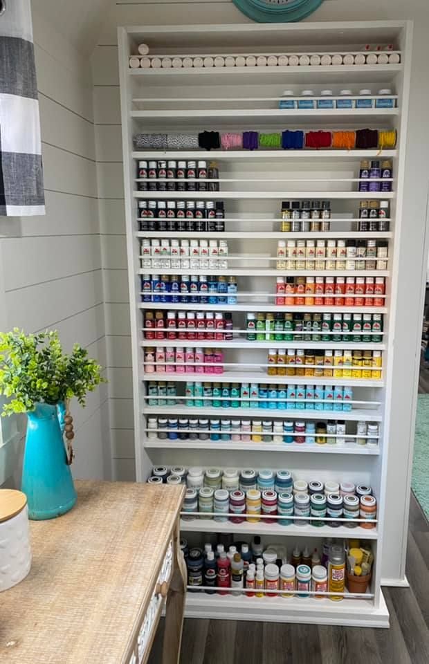 a shelf filled with lots of different types of paint