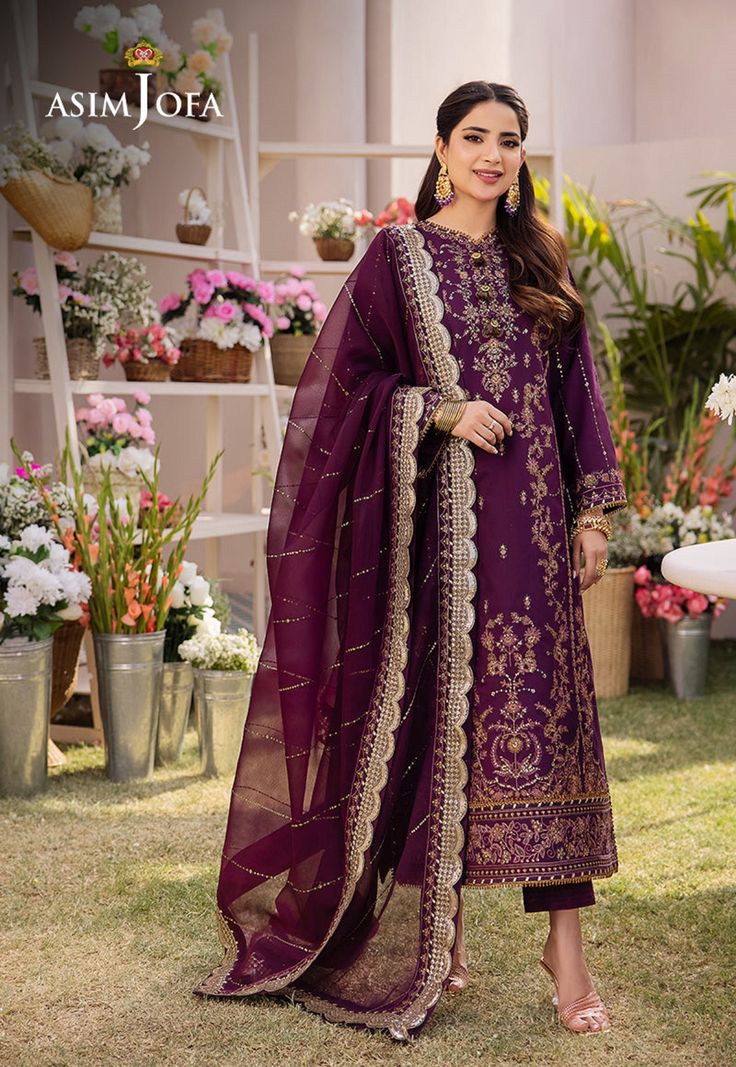 Shirt: Boski Silk By Pcs: 3 Pcs Trouser: Boski Silk Dupatta: Chiffon Color: Purple Product Details Inspiring old world charm this design exudes richness. Deep raisin shirt is embroidered to perfection with mauve, olive threads enhanced by two toned mink zari & light gold sequins. It is complemented by a lightly worked chiffon dupatta rendered in zari & sequins giving it a soft shine. DESIGN DETAILS: *Embroidered front center panel on boski silk *Embroidered side panels right & left for front on Eid Anarkali Kurta With Dupatta, Anarkali Kurta With Dupatta For Eid, Eid Anarkali Set With Pallu, Anarkali Cambric Kurta For Party, Festive Anarkali Unstitched Cambric Suit, Traditional Cambric Wear For Eid Festive Season, Traditional Cambric Wear For Eid, Festive Eid Unstitched Cambric Suit, Festival Anarkali Set With Sheer Dupatta