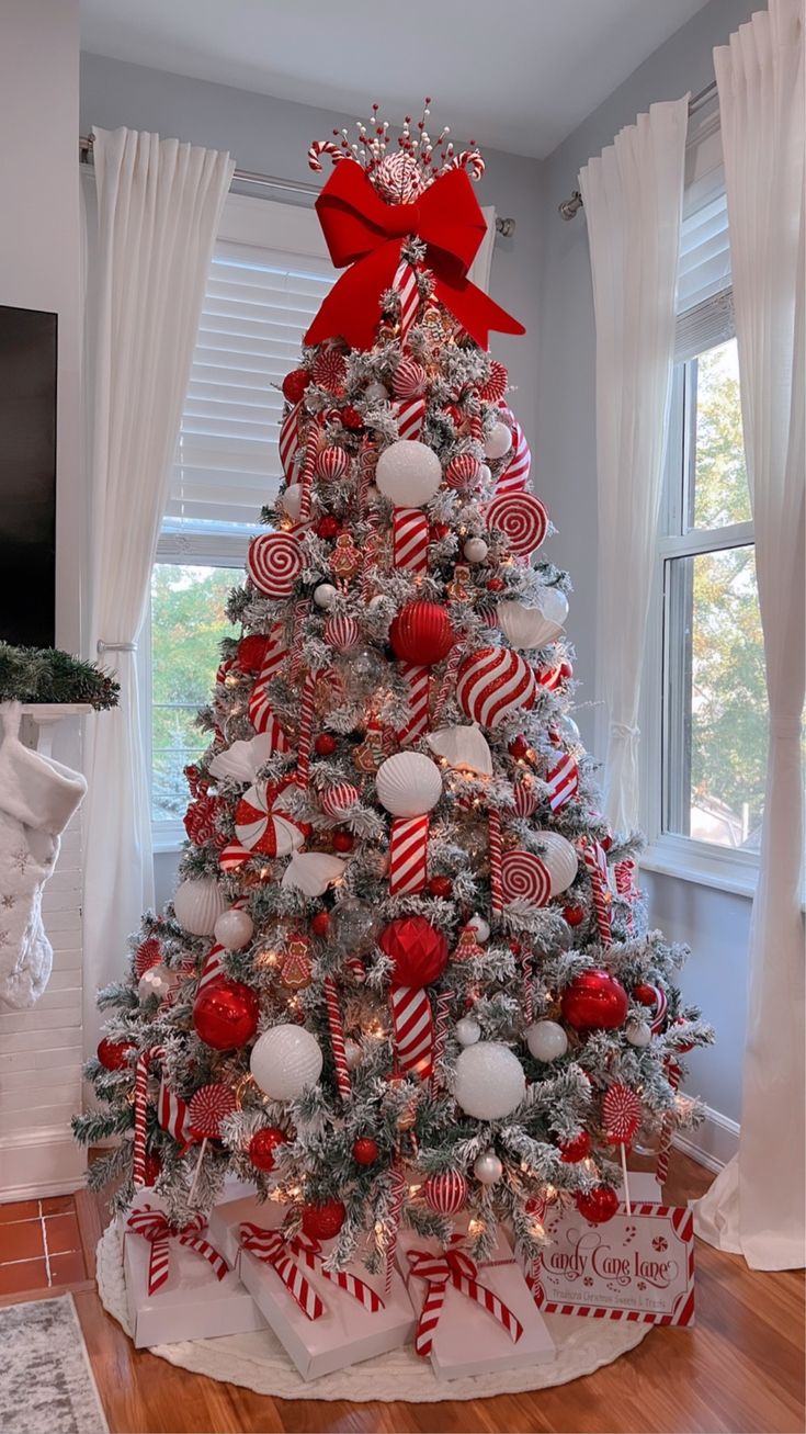 a decorated christmas tree with candy canes and ornaments in red, white and silver