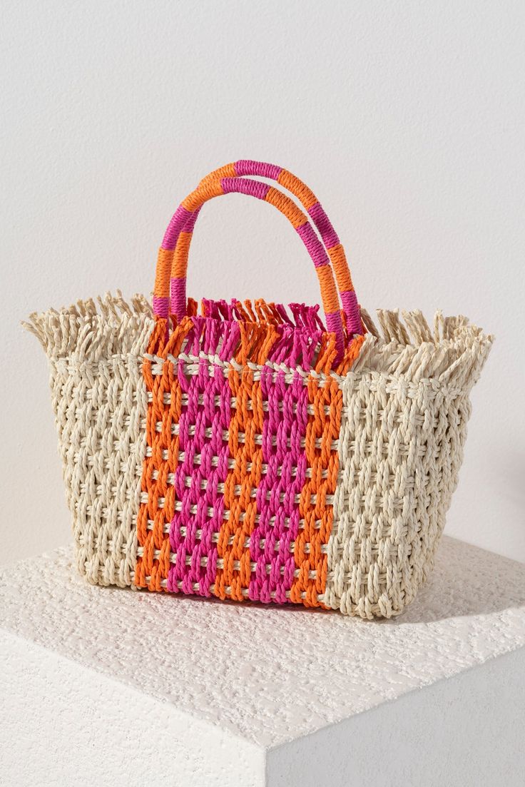 Stand out from the crowd this summer with Shiraleah's Sicily Mini Tote. Made from intricately woven paper straw with sturdy double handles, this bag is both practial and stylish. With its feminine orange and pink striped design it's easy to envision this bag alongside any warm weather outfit. Pair with other items from Shiraleah to complete your look! Chic Summer Style, Warm Weather Outfits, Straw Tote, Sunset Colors, Orange And Pink, Woven Paper, Paper Straws, Chic Handbags, Mini Tote