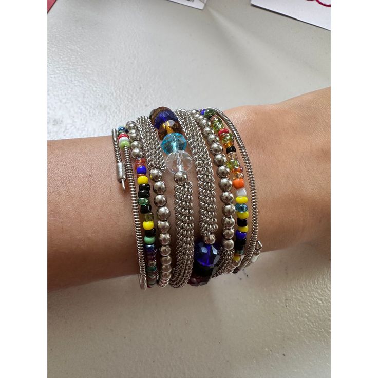 This Wrap Bracelet features colorful beads and an oxidized finish. The unique design allows for versatility in styling, adding a touch of color and texture to any outfit. Crafted with high-quality materials, it is a must-have accessory for any fashion-forward individual. One size fits all. Multicolor Wrap Bracelet As A Gift, Multicolor Wrap Bracelet As Gift, Multicolor Metal Beaded Bracelets For Festival, Trendy Multicolor Beaded Bracelets, Metal Beaded Bracelets For Festival, Metal Bracelet With Round Beads For Festivals, Trendy Colorful Party Bracelets, Festival Cuff Bracelet With Colorful Beads, Trendy Handmade Multicolor Beaded Bracelets