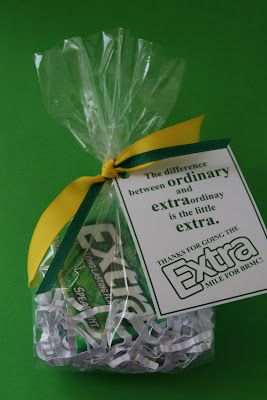 a bag filled with gummy bears sitting on top of a green table next to a yellow ribbon