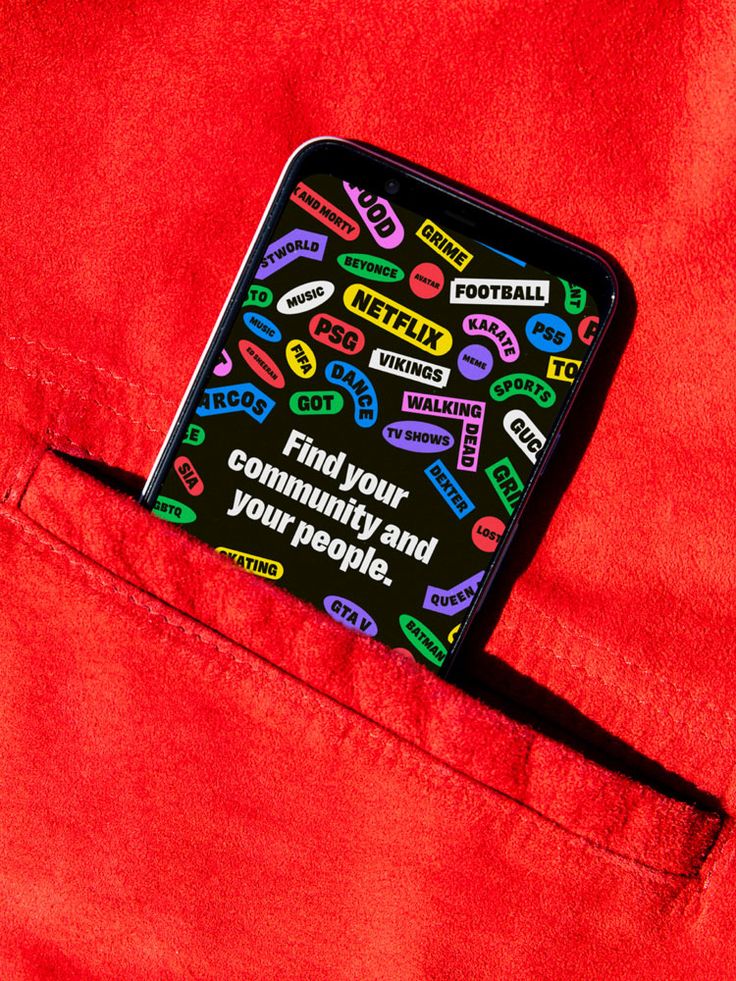 a cell phone is sitting in the pocket of a pair of red pants with colorful stickers on it