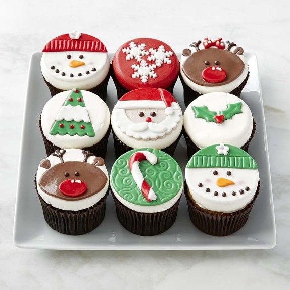 cupcakes decorated with frosting and christmas decorations