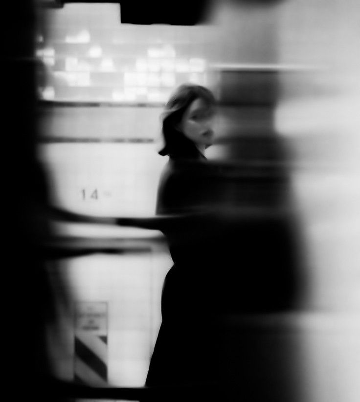 a blurry photo of a woman walking down the street