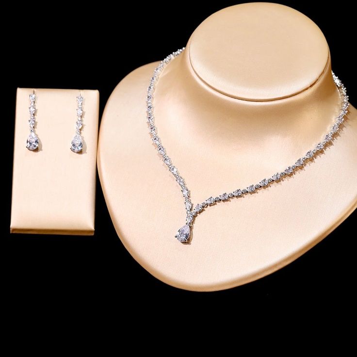 A beautiful three-piece bridal jewelry set that will add elegance and sophistication to any wedding gown or formal ensemble! Adorned with intricately faceted cubic zirconia that capture the light from every angle with a perfectly translucent appeal, the pieces are platinum plated for a flawless finish which enhances the intricate detailing and conveys a modern take on old elegance. Necklace: 17" (approx. 43cm) long with a secure fold-over closure (a 2" extension chain can be added upon request, Elegant Silver Bridal Sets With Rhinestones, Elegant Cubic Zirconia Bridal Sets, Elegant Diamond White Bridal Sets With Sparkling Stones, Elegant Bridal Sets With Rhinestones And Crystal, Elegant Crystal Bridal Sets With Rhinestones, Elegant Diamond White Jewelry Sets With Rhinestones, Elegant Formal Crystal Bridal Sets, Elegant Diamond White Crystal Wedding Accessories, Elegant Crystal Bridal Sets For Formal Occasion