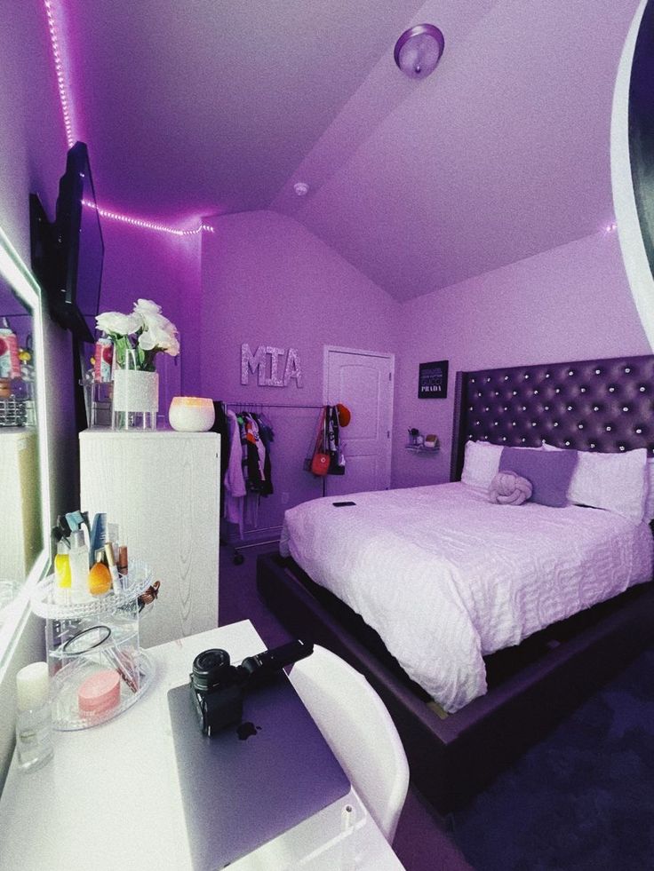 a bed room with a neatly made bed and purple lighting