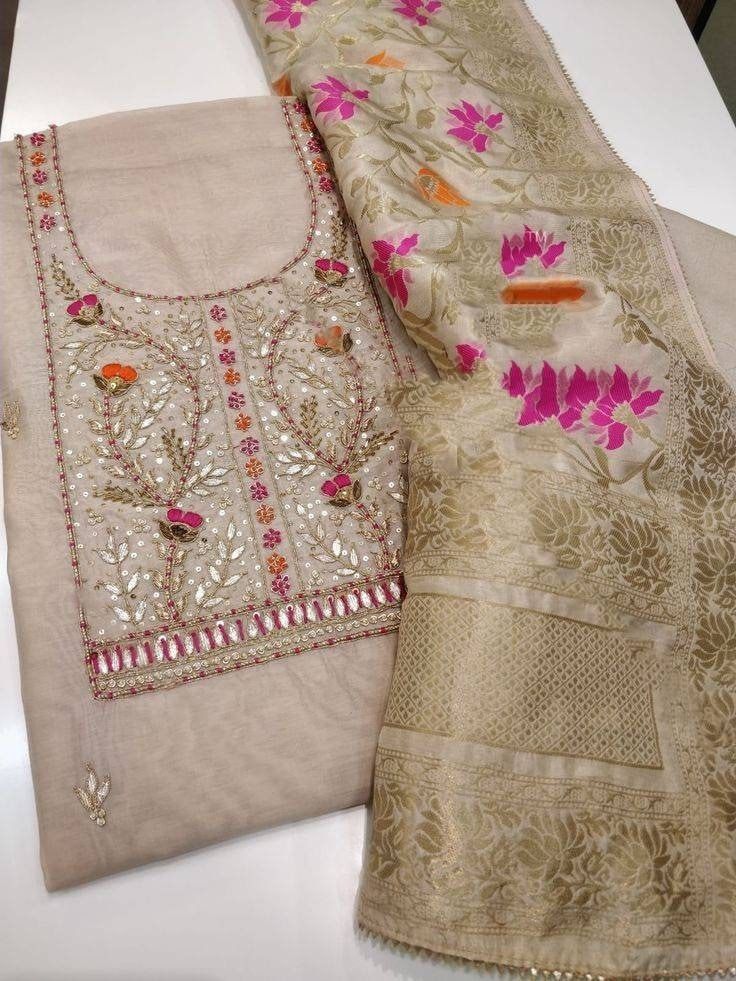 Item Overview ATHARVA Hand Embroidery Indian Salwar Kameez/Beige Chanderi/Banarsi Meenakari Dupatta/Gota Patti/Custom Stitch Unstitch/Plazzo/Patiala/Gift Dno. CH2120 Fabric:  * Shirt- Chanderi Silk - Embroidered Neck ( Beige) - 2.5 Mts Beautiful Hand Embroidery * Dupatta: Banarsi Silk Dupatta- Zari Meenakari Dupatta- 2.5 Mts- Latkans Tassels- (Motifs may wary) * Bottom Santoon Silk 2.5 Mts. Excusive Hand Embroidered Party Wear Punjabi Suit. 🌷CUSTOMIZATION (No Extra Charges) * Fabrics Customizat