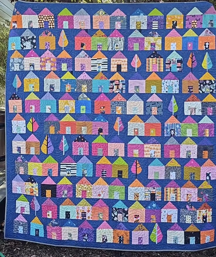 a blue quilt with houses on it