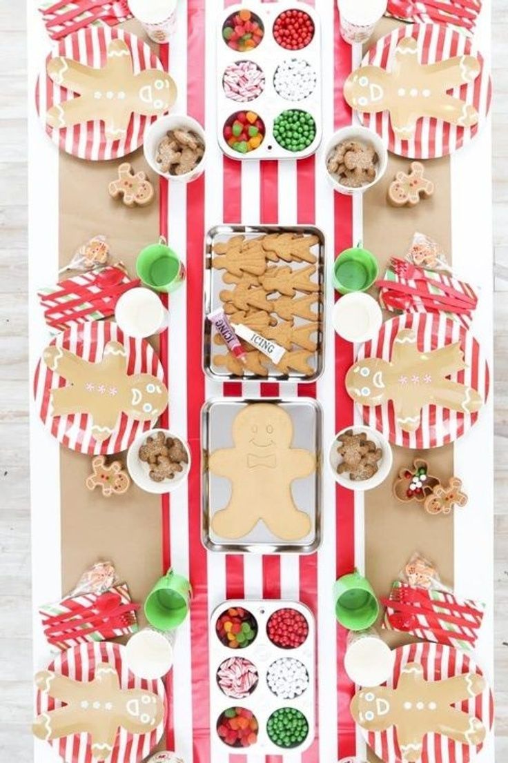 an assortment of cookies and candies are arranged on a table with red and white striped paper